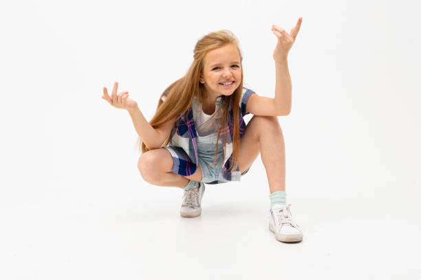 istock funny girl squatted and waves her hands on a white background 1193286731