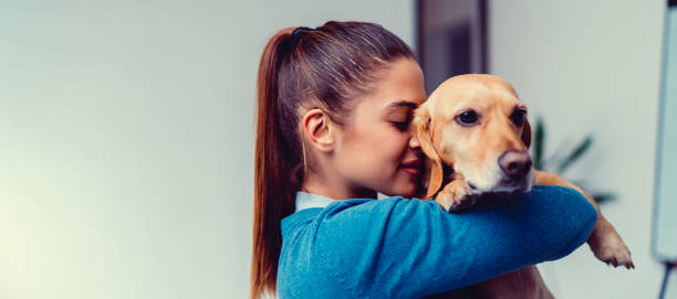 istock Young woman embracing small brown dog 1193287826