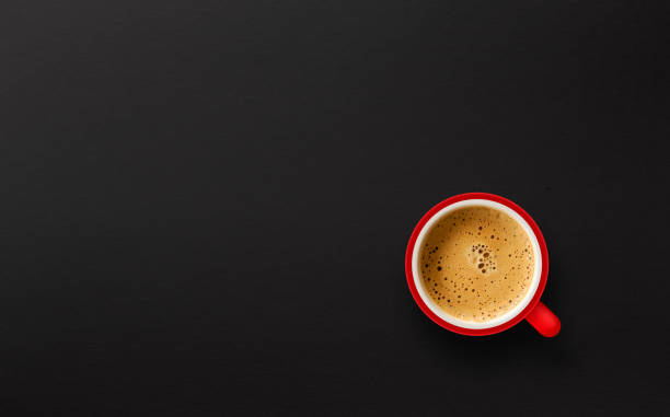 istock red cup of coffee on black paper background. top view 1193287907