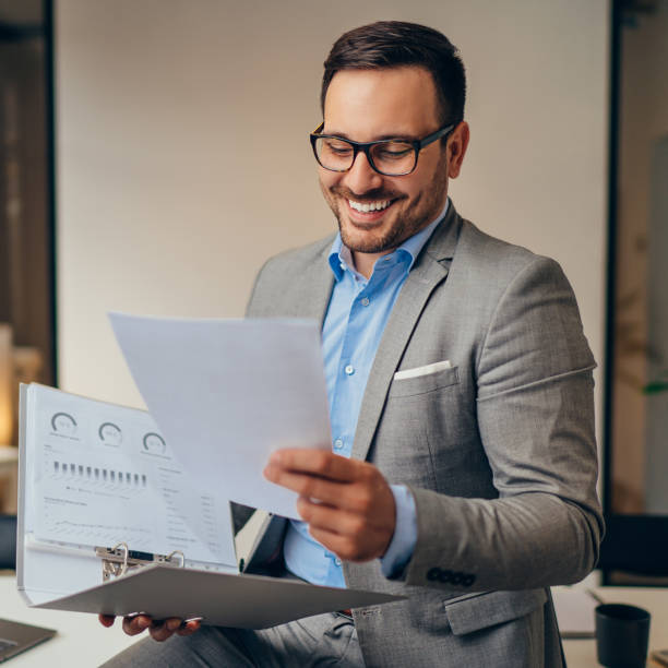 istock Young businessman doing paperwork in hes office 1193288687