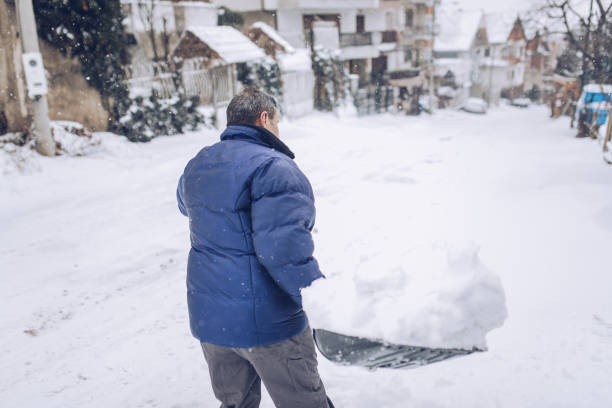 istock Older man clearing snow in the street 1193289070