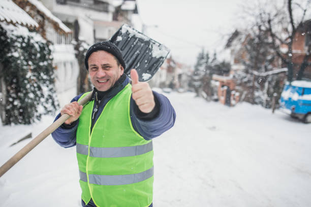 istock Senior man clearing snow in the street 1193289727