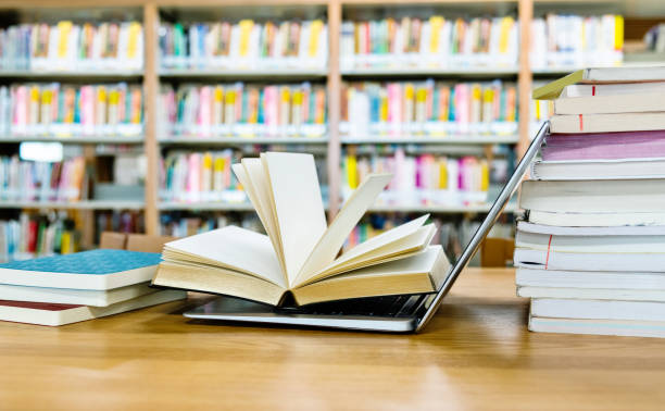 istock Open book on the laptop keyboard 1193289861
