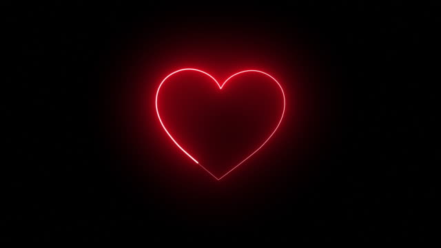 Red shiny glowing heart shape with a disco light on a black background - loop