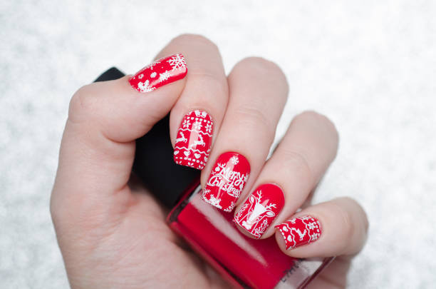 istock red Christmas manicure with deer and snowflakes 1193290070