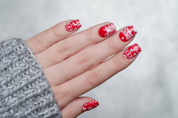 istock red Christmas manicure with deer and snowflakes 1193290079