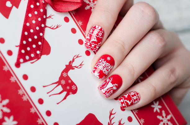 istock red Christmas manicure with deer and snowflakes 1193290140
