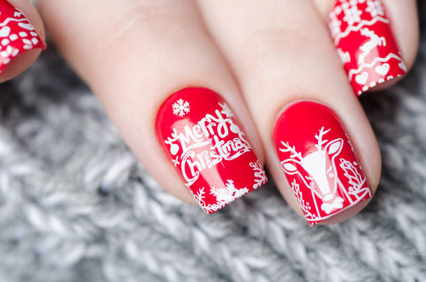 istock red Christmas manicure with deer and snowflakes 1193290162