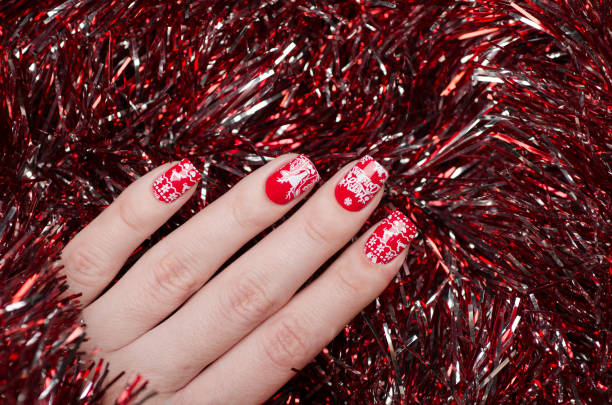 istock red Christmas manicure with deer and snowflakes 1193290181