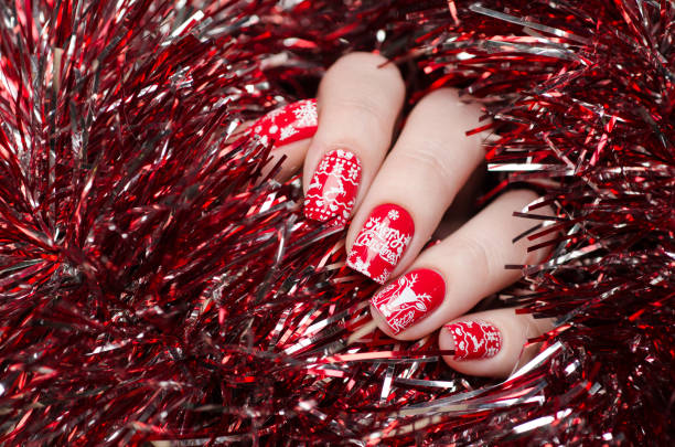 istock red Christmas manicure with deer and snowflakes 1193290205