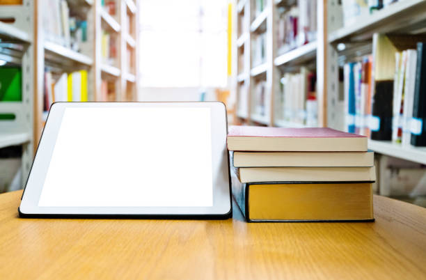 istock Digital tablet and books on wooden table 1193291291