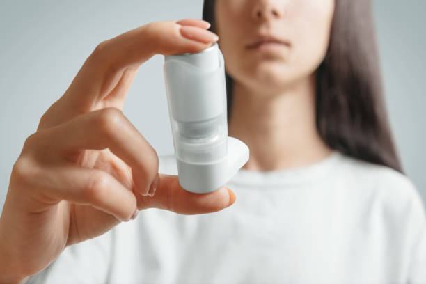istock Woman holding inhaler against asthma attack. 1193291552