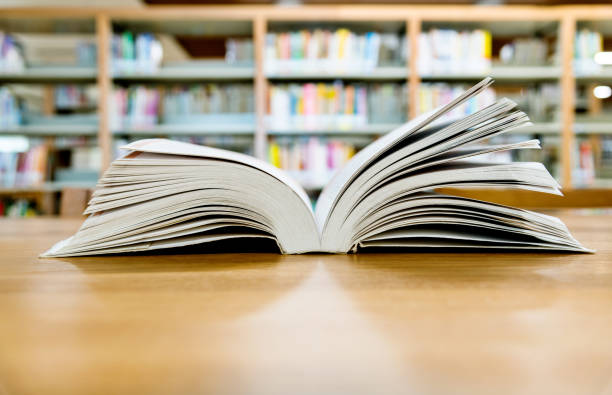 istock Open book on the desk of library 1193292163