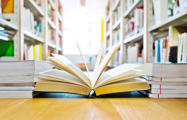 istock Open book on the desk of library 1193292327