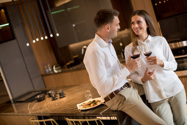 istock Sweet couple having drinking red wine after a romantic dinner at luxury kitchen 1193293089