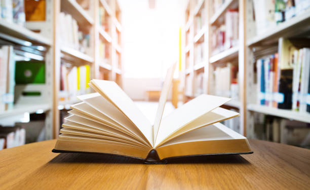 istock Open book on the desk of library 1193293212