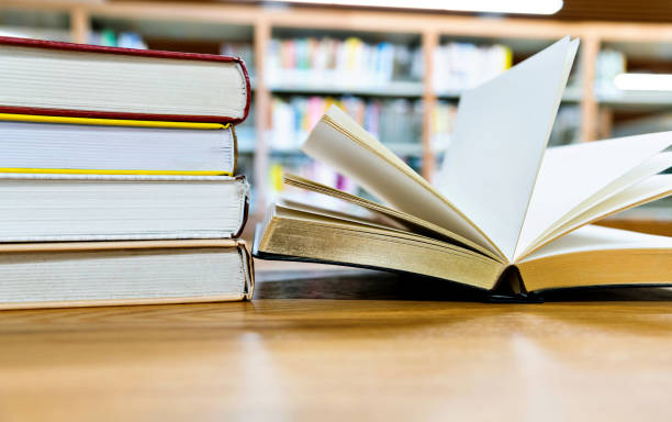 istock Open book on the desk of library 1193293486