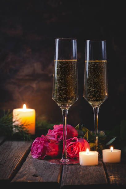istock Two Glasses of Champagne and Red Roses 1193293566