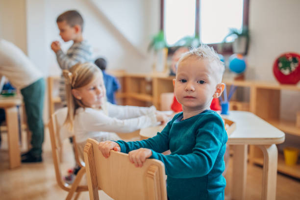 istock Boy with friends in preschool classroom 1193293715
