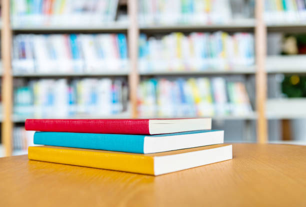 istock Stack of books on the desk of library 1193294575