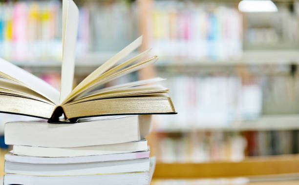 istock Open book on the desk of library 1193294832