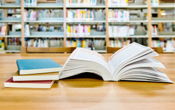 istock Open book on the desk of library 1193294834