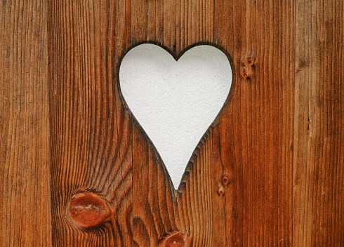 Heart shape in the wooden board (clipping path included)
