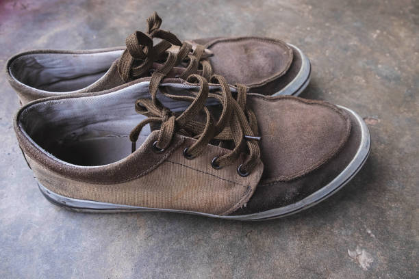 istock Old canvas shoes on the floor 1193295916