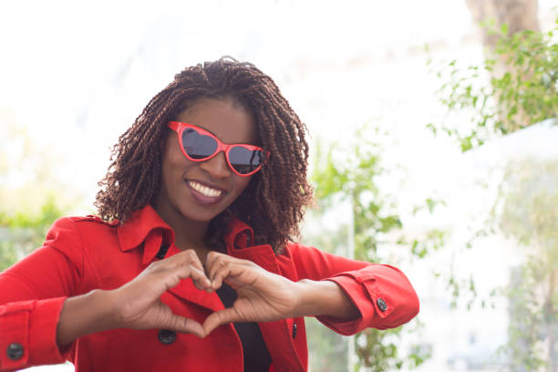 istock Content young woman showing hand heart symbol 1193296410