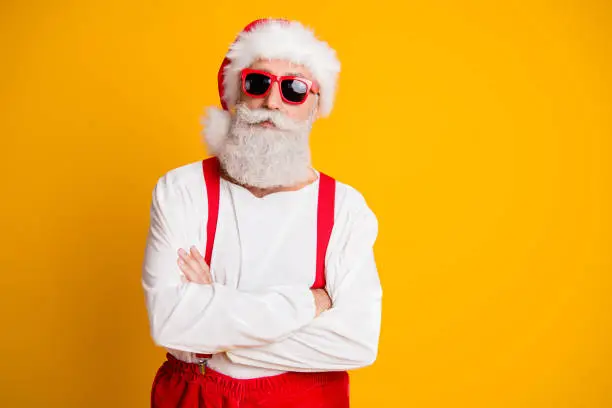 Portrait of serious santa claus from noel north-pole in red hat cross hands look, confident on x-mas newyear party isolated over shine color background