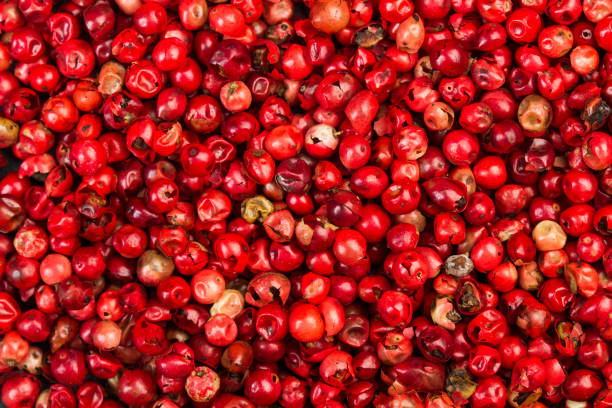 istock Pink peppercorns in a close up view 1193297113