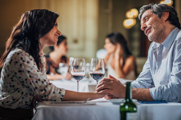 istock Couple holding hands on a date in restaurant 1193298572