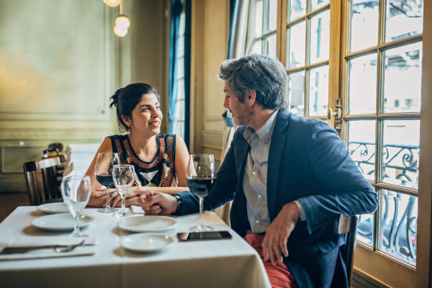 mature couple on a date in restaurant - restaurant wine table table for two imagens e fotografias de stock