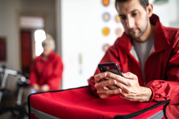 istock Delivery worker checking directions on smartphone 1193301595