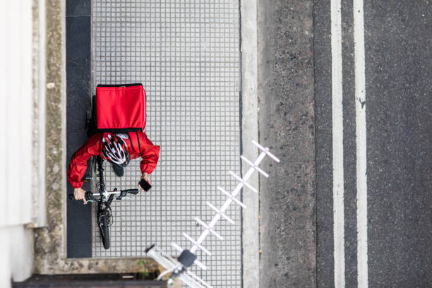 istock Courier on bicycle using phone on the street 1193301643