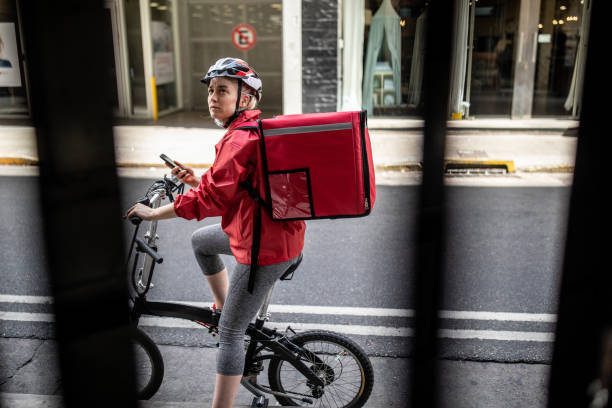 istock Bicycle delivery woman checking directions on smartphone 1193301645
