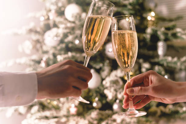 Celebration christmas and new year. Couple holding glasses of sparkling wine stock photo