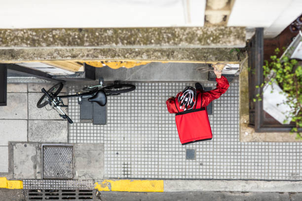 istock Directly above delivery man ringing the door bell with order 1193301918