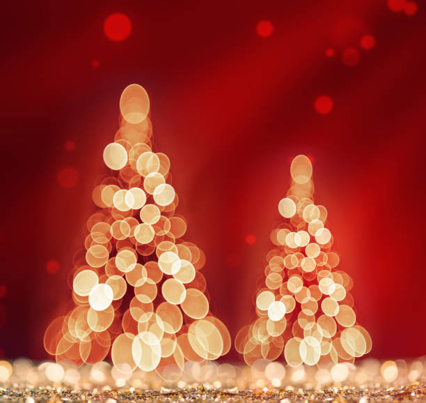 istock Red light and two christmas tree on defocused sparkles background 1193302290