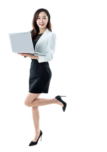 istock Businesswoman standing and using laptop on white background 1193306173