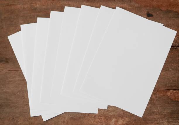 istock White paper set on wood background. 1193306360