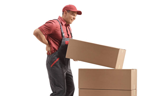 istock Male worker lifting a package and holding his painful back 1193306503