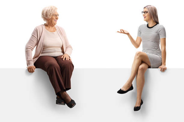 istock Senior and young woman sitting on a panel and having a conversation 1193306783