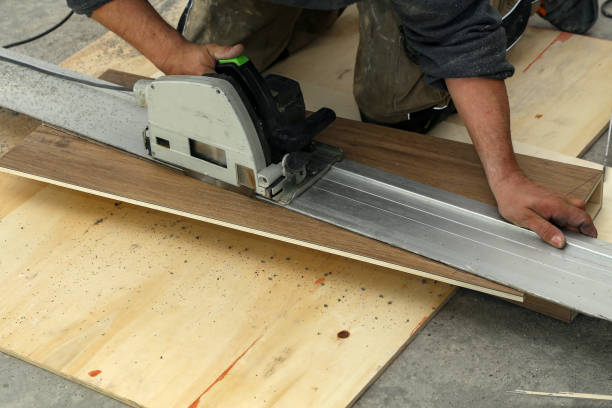 istock Worker measures and saws off fragments of steps for stairs 1193307643
