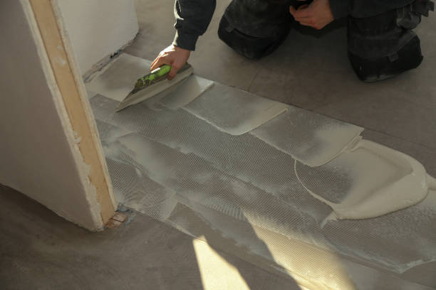 istock The worker installing new vinyl tile floor 1193308158