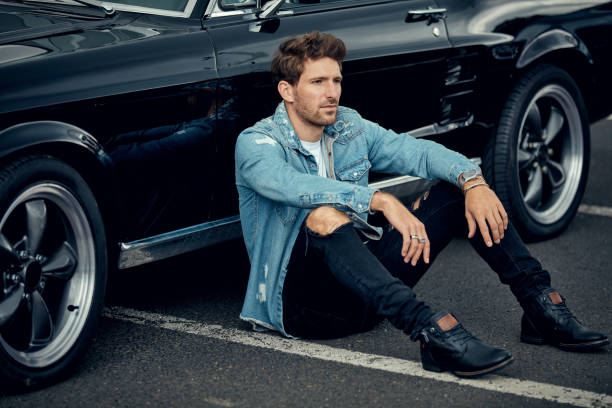 istock Handsome man with black classic car 1193309501