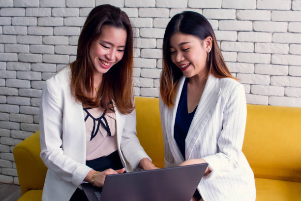 istock Two business women are using laptop for working 1193310273