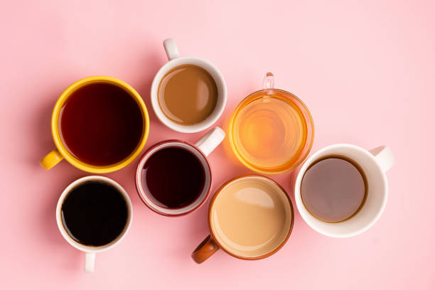 istock Mugs glasses with various traditional drinks coffee tea juice on pink background. Flat layout top view. Drinks concept. 1193310805
