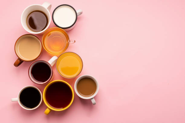 istock Mugs glasses with various traditional drinks coffee tea juice on pink background. Flat layout top view. Drinks concept. 1193310811