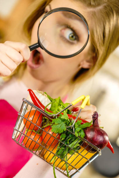 istock Woman investigating shopping backet with vegetables 1193312455